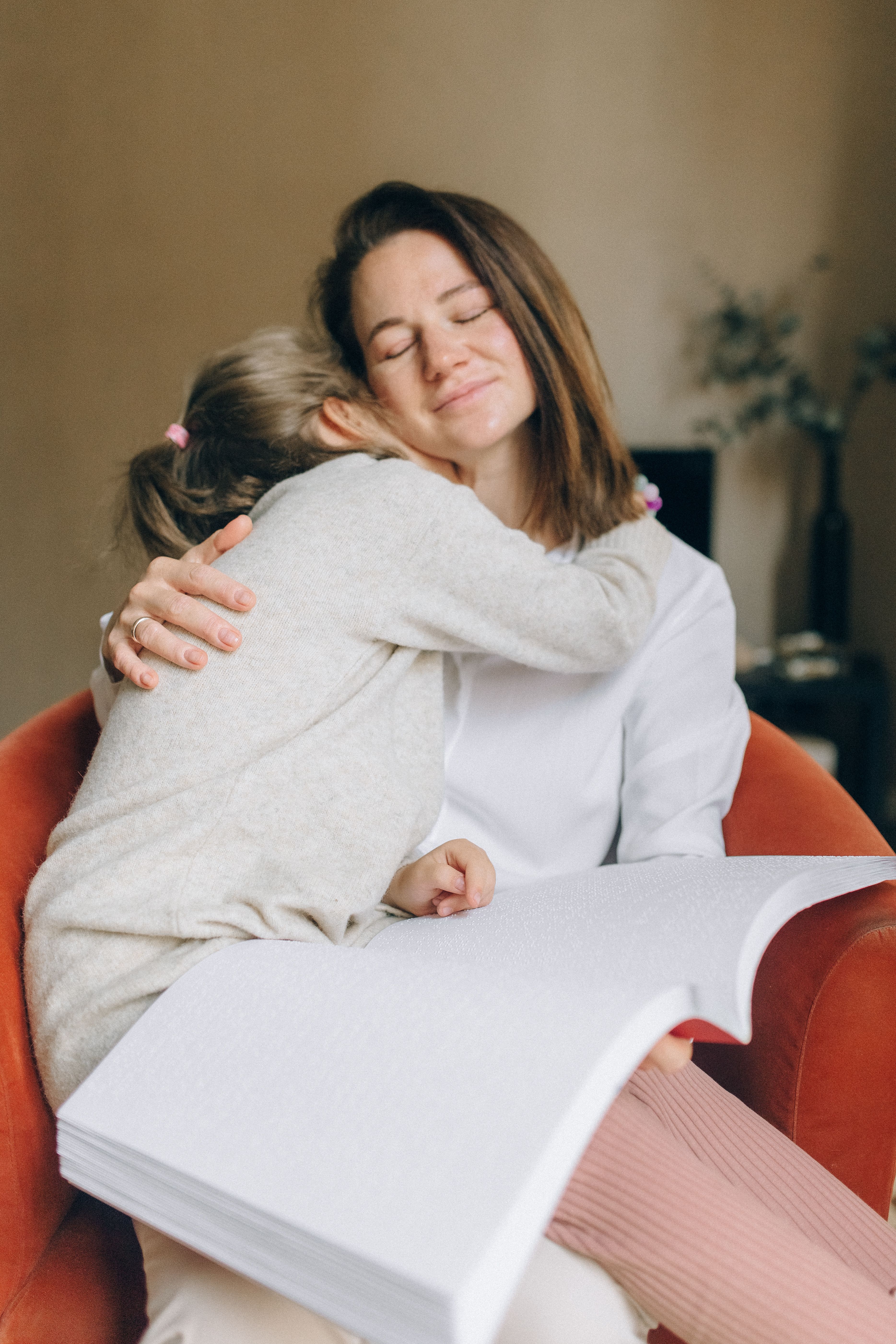 A mother warmly embracing her daughter at home